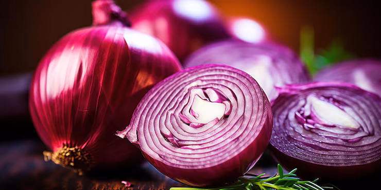 Slices of fresh red and yellow onions on a wooden board, showcasing immune-supporting quercetin and prebiotic inulin.