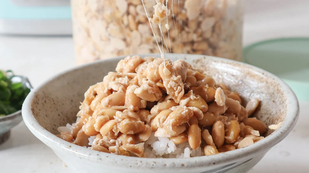 Traditional Japanese natto fermented soybeans showing sticky probiotic mucilage threads rich in Nattokinase and Vitamin MK-7 K2.