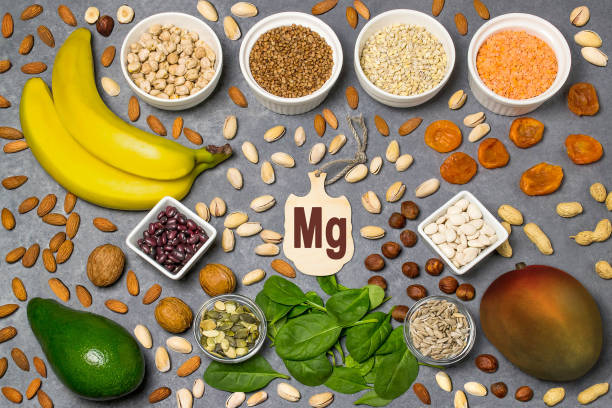 A nutrient-rich selection of magnesium foods including boiled spinach, pumpkin seeds, dark chocolate, and almonds.